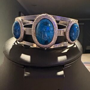 This is a Roma faux turquoise oval-shaped cuff bracelet.